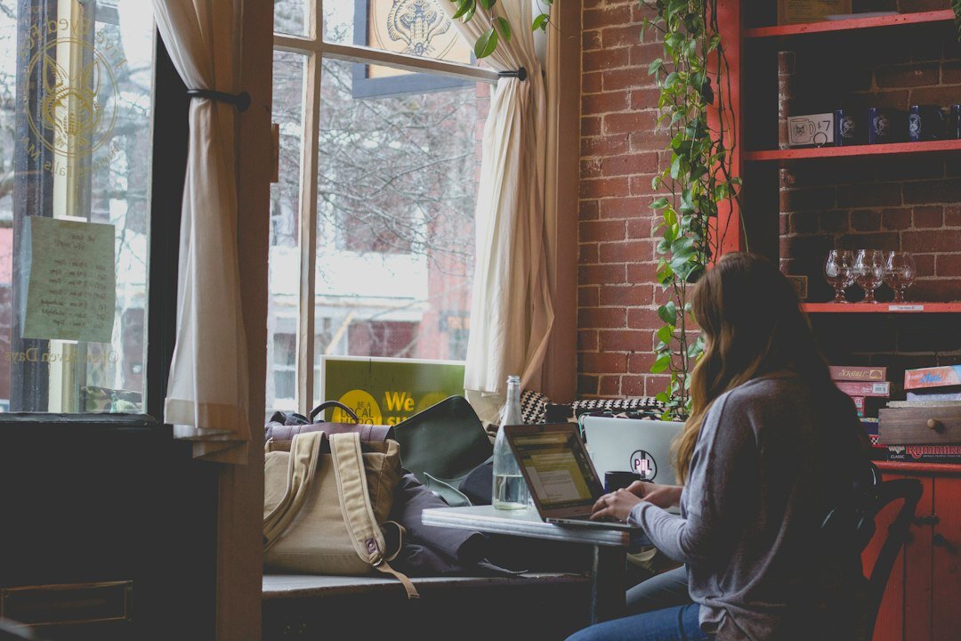 programmer working on laptop in cafe