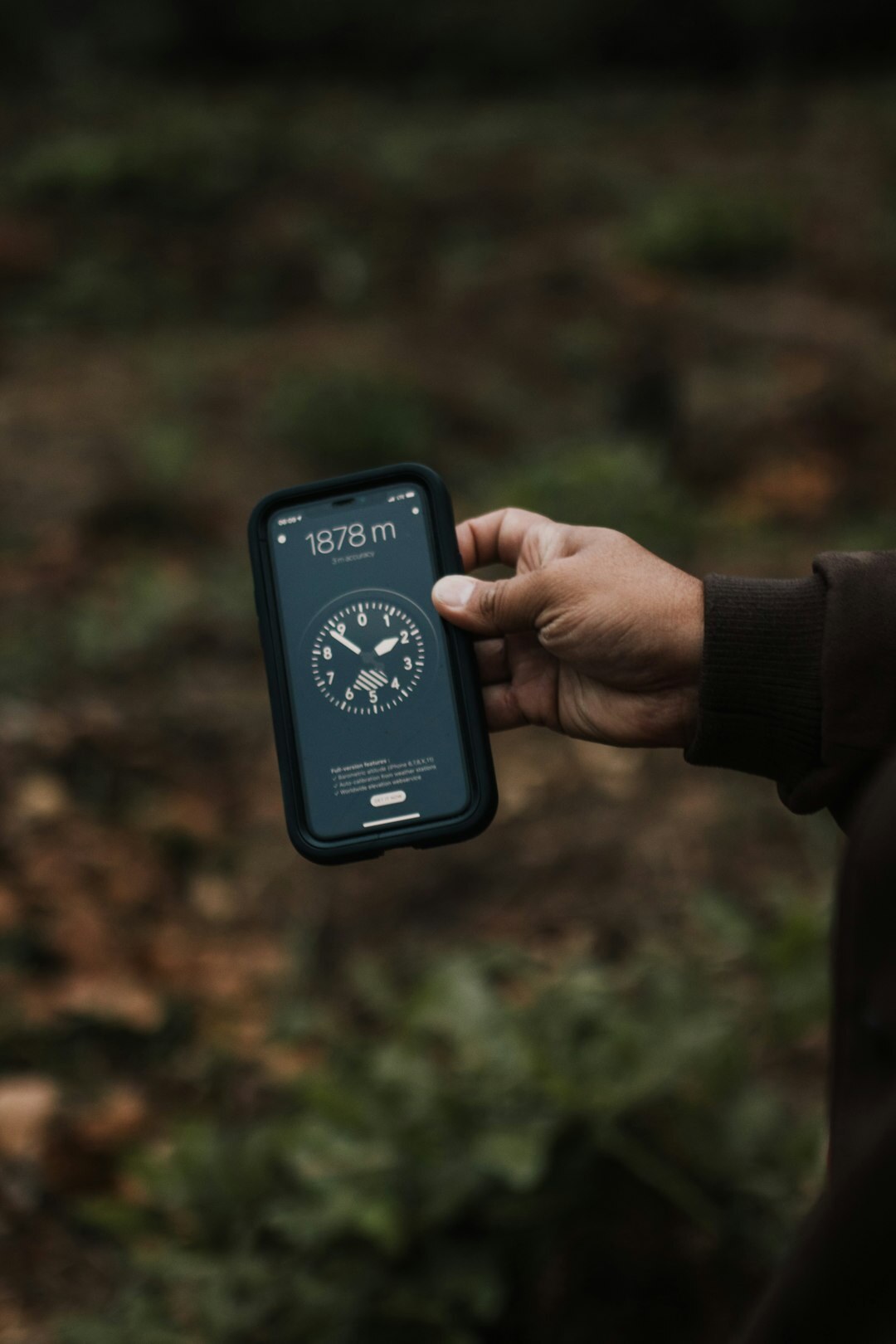 Hands holding a smartphone showing an app interface