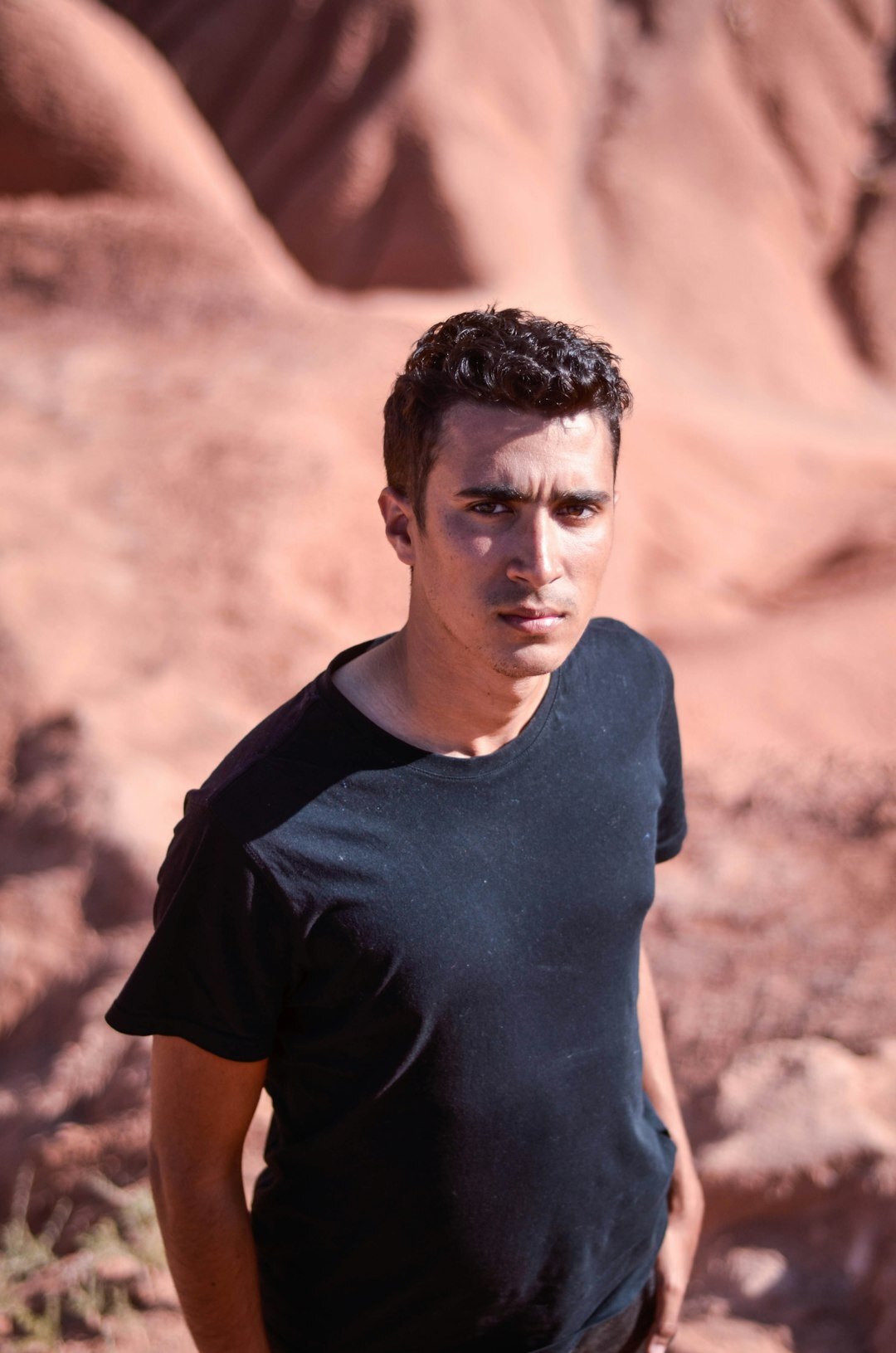 Professional headshot of a Latino male programming instructor