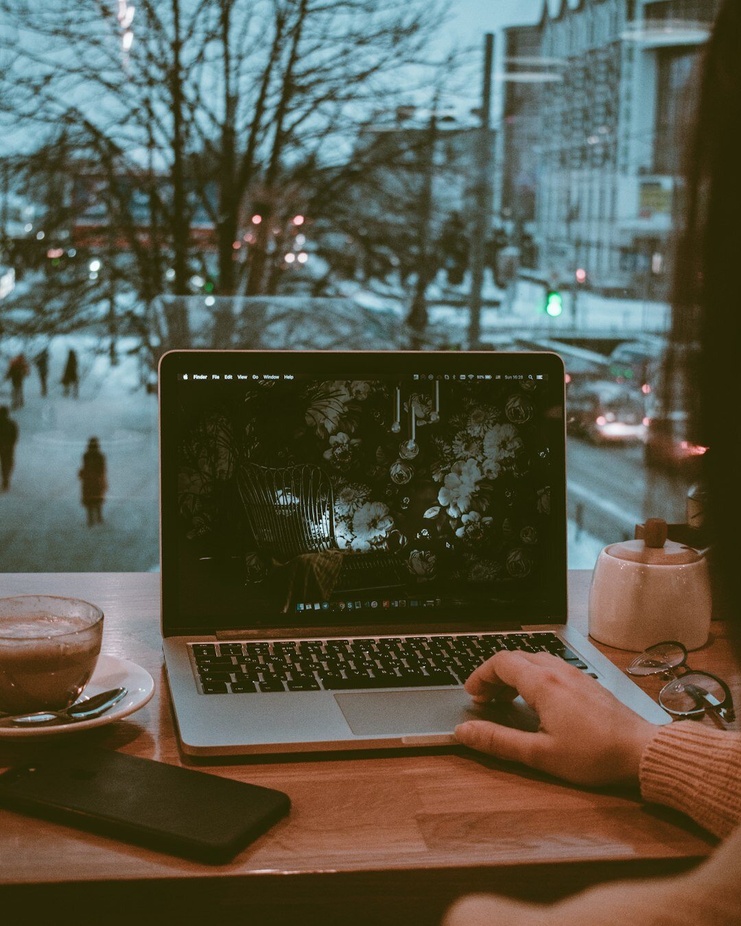 programmer working on laptop in cafe