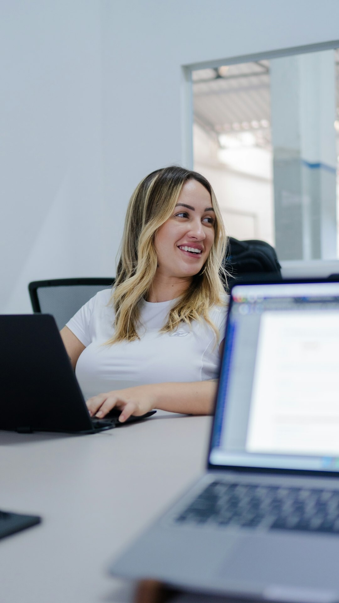 young woman coding on laptop