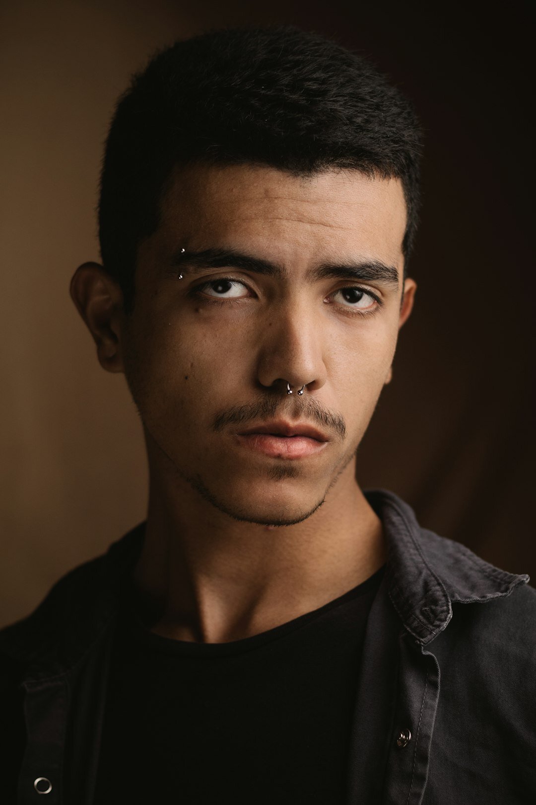 Professional headshot of a young Latino male developer